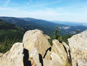 Scenic view of rocks and mountains against sky