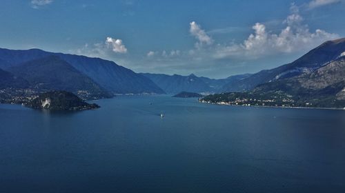 Scenic view of sea and mountains against sky