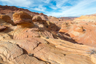 Scenic view of rock formations against cloudy sky