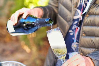 Midsection of man drinking glass