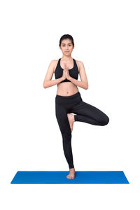 Full length portrait of young woman against white background