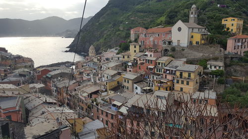 High angle view of residential district by mountain and river