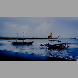 Fishing boat in sea against sky