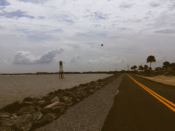 Road by sea against sky