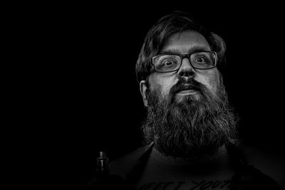 Portrait of man against black background