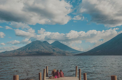 San marcos de laguna, guatemala, travelers sitting in front of the atitlan lake