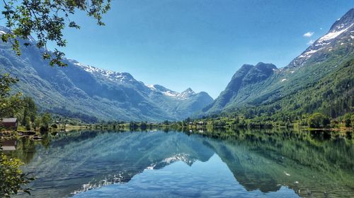 Scenic view of lake and mountains against sky