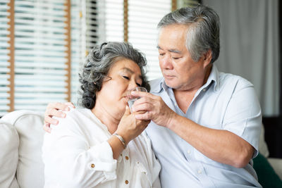 Senior couple sitting at home