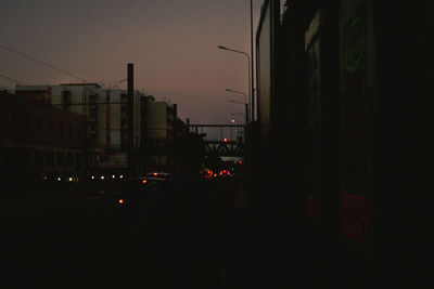 City street against sky at night