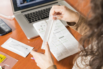 Midsection of woman holding test kit