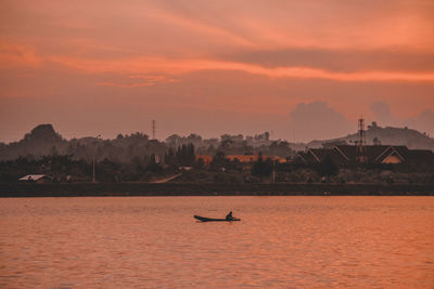 Scenic view of sea against orange sky