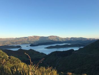 Scenic view of mountains against clear blue sky