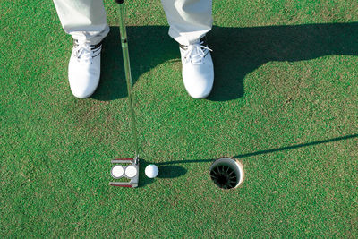Low section of person standing on golf course