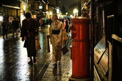 People walking on street at night