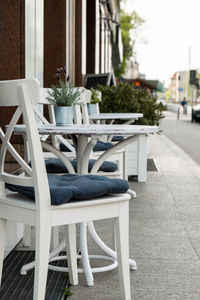 Outdoor table in street cafe. outdoor empty coffee and restaurant terrace with potted plants tables