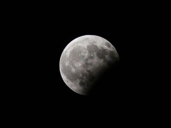 Low angle view of moon against clear sky at night