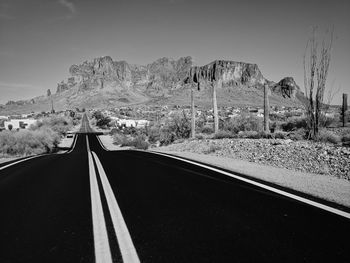 Empty road along countryside landscape