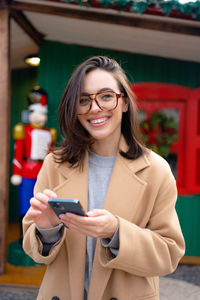 Portrait of young woman using mobile phone