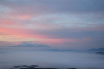 Scenic view of mountains against sky at sunset