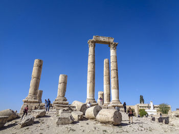 Ruins of temple against clear blue sky