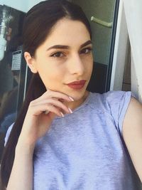 Close-up portrait of young woman sitting in car