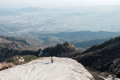 High angle view of man standing on mountain peak