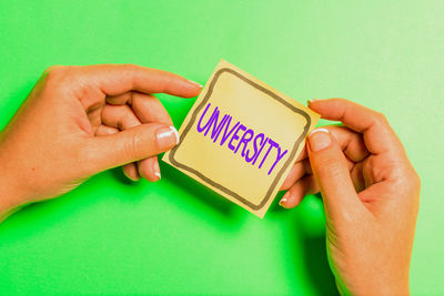 Close-up of man holding hands over white background