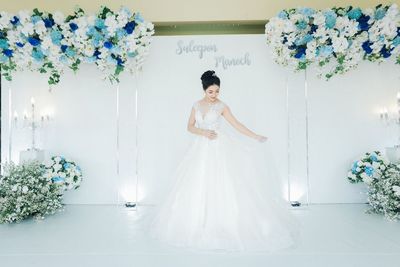 Woman standing against white wall