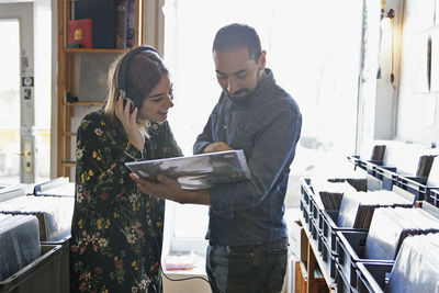 Young couple shopping for records together