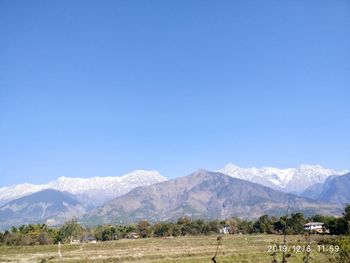 Scenic view of mountains against clear blue sky