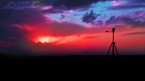 Silhouette electricity pylon on field against sky during sunset