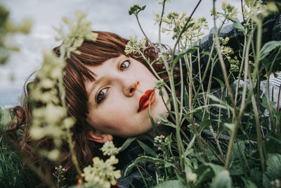 Portrait of beautiful young woman in field