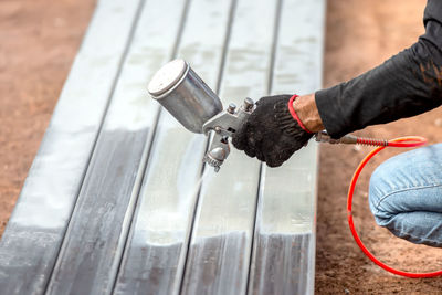 High angle view of man working on metal