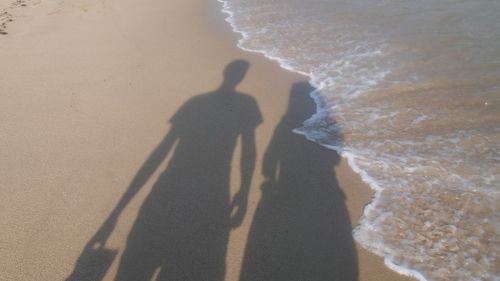 Shadow of people on beach