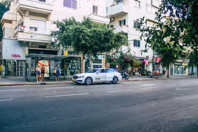 Cars on street against buildings in city