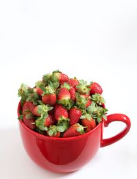 Close-up of strawberries in bowl against white background