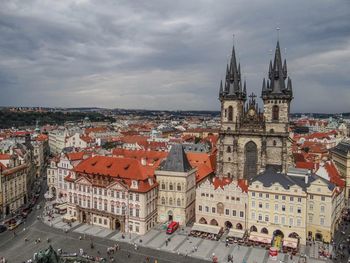 Buildings against cloudy sky