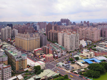 High angle view of buildings in city against sky