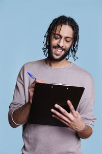 Portrait of young woman using digital tablet