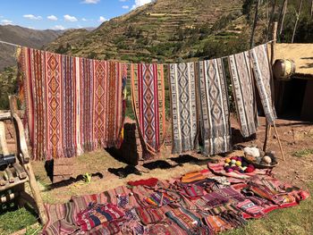 Clothes drying on clothesline on field against sky