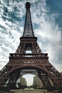 Low angle view of tower against cloudy sky