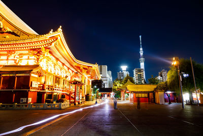 Illuminated buildings in city at night