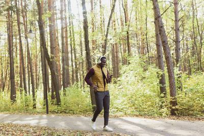 Rear view of woman walking in forest