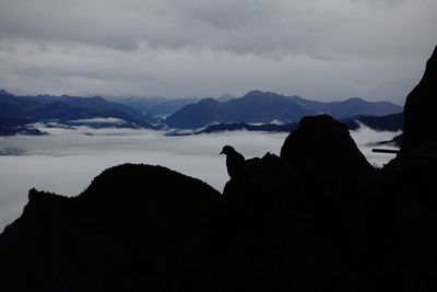 Scenic view of silhouette mountains against sky