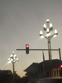 Low angle view of street light against building