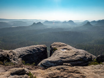 End of the rocky edge. fantastic sunrise on the top of rocky mountain with view into misty valley