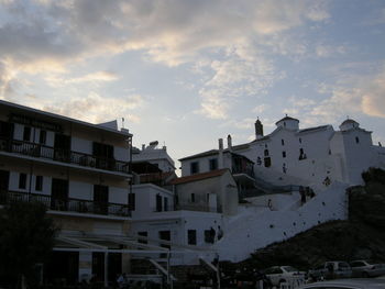 Buildings against cloudy sky