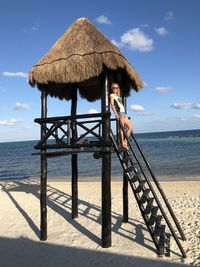 Lifeguard hut on beach against sky