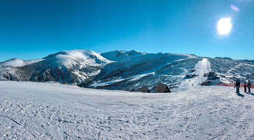 Snow covered mountain against blue sky