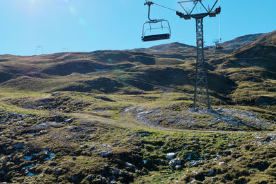 Overhead cable car over mountains against sky